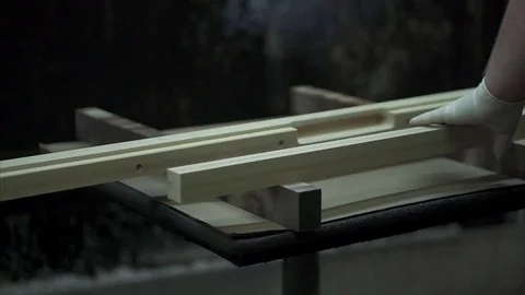 A man covers a tree with paint, paints a part with a spray. A factory worker  Stock Footage 84043349