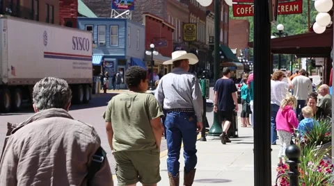 Man in Cowboy Hat and Tourists Cross Gold Street Stock Footage