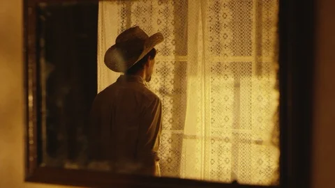 Man cowboy is looking thru the window 스톡 동영상 111229611