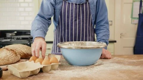 Man Cracking Eggs In Bowl At Messy Table Stock Footage 86074573