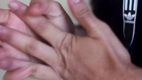 Man cracking finger knuckles or joints Stock Footage 148409650