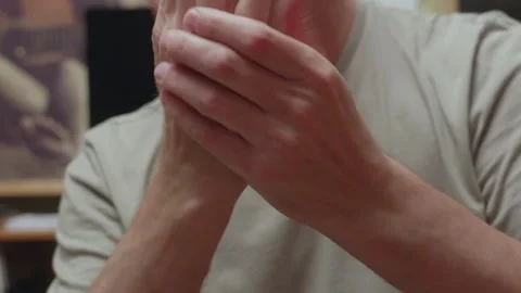 Man cracking knuckles close up hands showing finger joint popping gesture detail Video stock 320263216