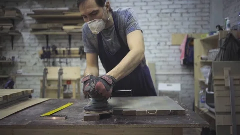 Man is craft working at a work bench with power tools Stock Footage 102785007