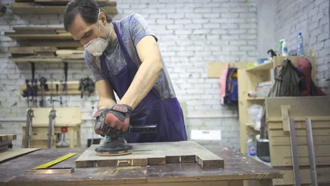 Man is craft working at a work bench with power tools Stock Footage 102785014