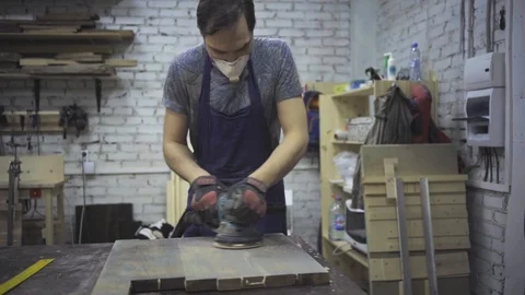Man is craft working at a work bench with power tools Stock Footage 102785028