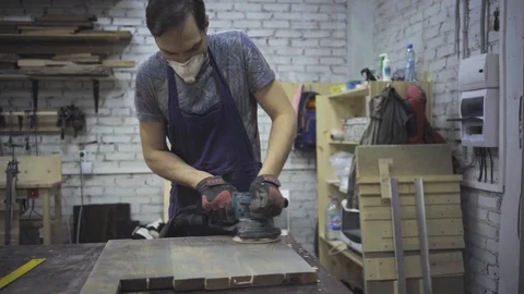Man is craft working at a work bench with power tools Stock Footage 102785034