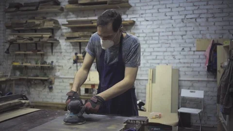 Man is craft working at a work bench with power tools Stock Footage 102785121