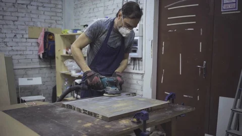 Man is craft working at a work bench with power tools Stock Footage 102785122