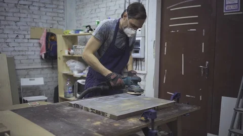 Man is craft working at a work bench with power tools Stock Footage 102785126