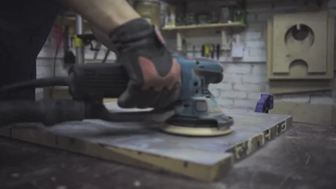 Man is craft working at a work bench with power tools Stock Footage 102785154