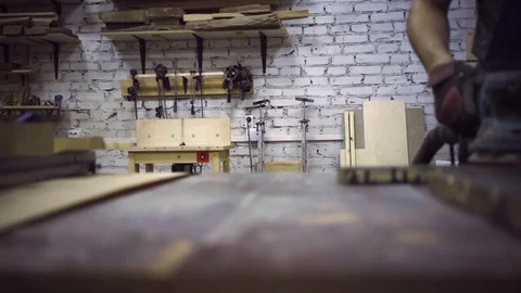 Man is craft working at a work bench with power tools Stock Footage 102785242
