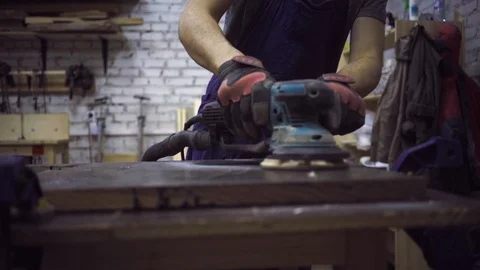 Man is craft working at a work bench with power tools Stock Footage 102785278