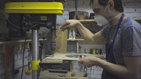 Man is craft working at a work bench with power tools Stock Footage 102857853
