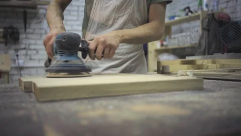 Man is craft working at a work bench with power tools Stock Footage 102858004
