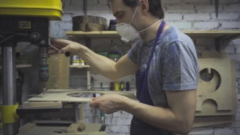 Man is craft working at a work bench with power tools Stock Footage 102858006