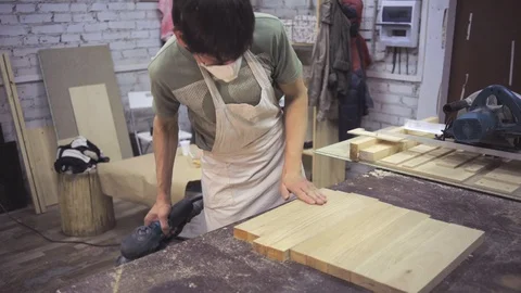 Man is craft working at a work bench with power tools Stock Footage 102858054