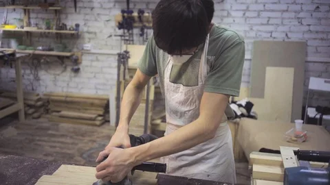 Man is craft working at a work bench with power tools Stock Footage 102858158