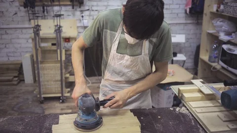 Man is craft working at a work bench with power tools Stock Footage 102858296