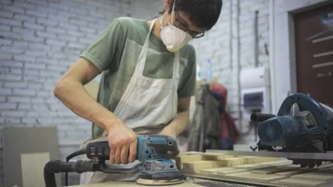 Man is craft working at a work bench with power tools Stock Footage 102858298