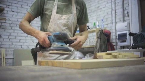 Man is craft working at a work bench with power tools Stock Footage 102858369