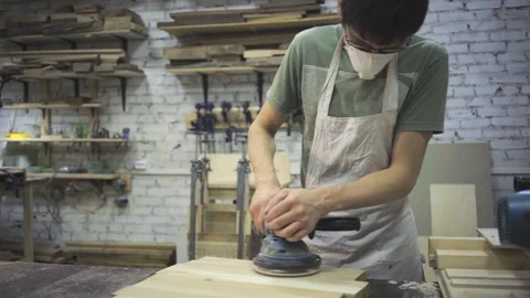 Man is craft working at a work bench with power tools Stock Footage 102858452