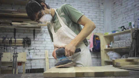 Man is craft working at a work bench with power tools Stock Footage 102858666