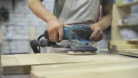Man is craft working at a work bench with power tools Stock Footage 102858679