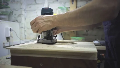 Man is craft working at a work bench with power tools Stock Footage 102902442