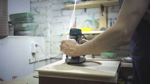 Man is craft working at a work bench with power tools Stock Footage 102902613