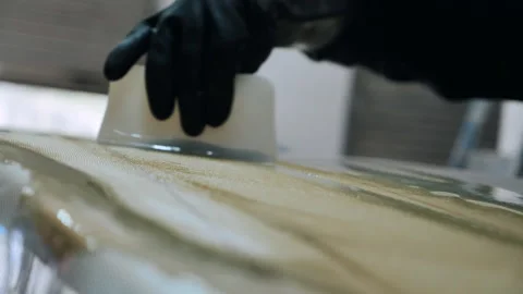 Man crafts unique surfboard at his shaping workshop in California Stock Footage 321580226