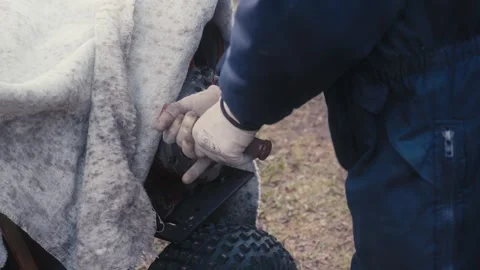 Man Cranking a Covered Engine on Farm Equipment Video stock 306323262
