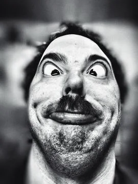Man with a crazy face posing for the camera Фото