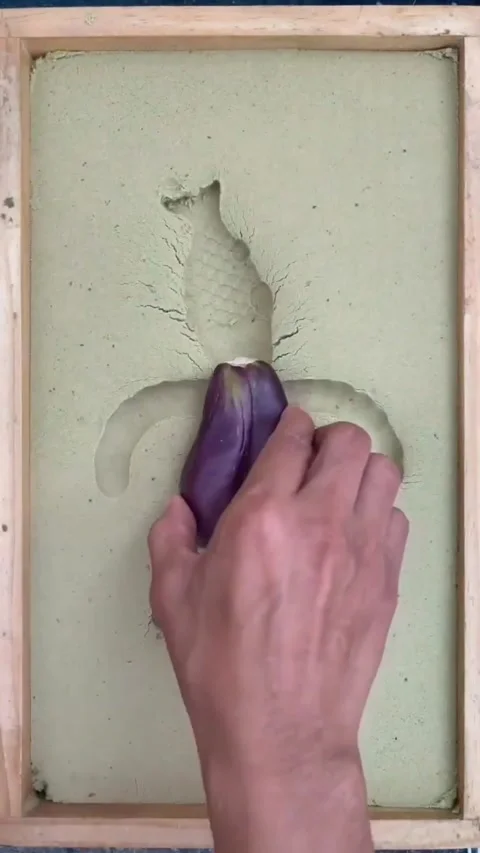 A man creates beautiful art using candles and eggplant Stock Footage 292815677