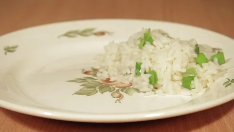 Man creates dishes portion from chicken wings with rice Stock Footage 70993887
