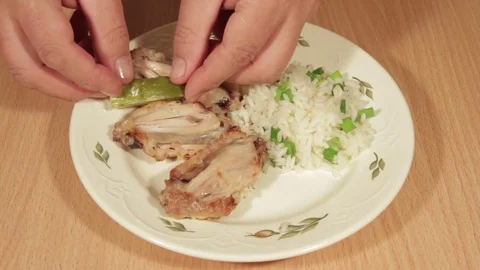 Man creates dishes portion from chicken wings with rice Stock Footage 70993954