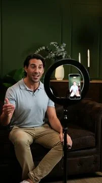 Man creating content using smartphone and ring light Stock Photos