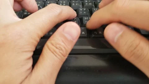 A man creating a document by fast typing words on a black keyboard Stock Footage 130632906