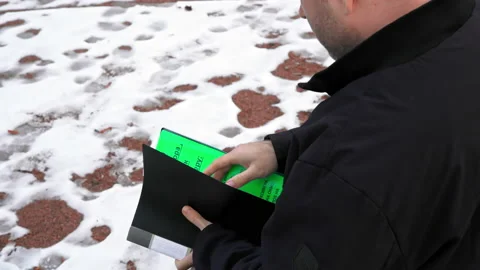 A man of criminal appearance prepares papers and goes Stock Footage 169285140