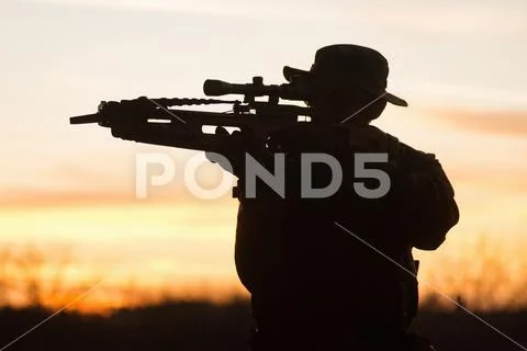 Man with crossbow silhouette Stock Photos