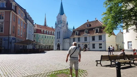 Man crosses amazing square surrounded by ancient buildings Video stock 112404048