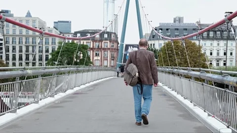 A man crosses the bridge with a backpack Stock Footage 245414170