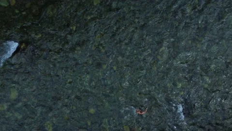 A man crosses a mountain river with a strong current. Aerial photography. Stock Footage 201656278