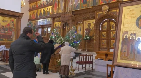 A Man Crossing Himself Before an Old Iconostasis, Which Looks Gorgeous and Stock Footage 58914034
