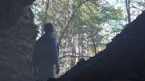 Man Crossing Mountain Stream in Wild Nature Stock Footage 264668398