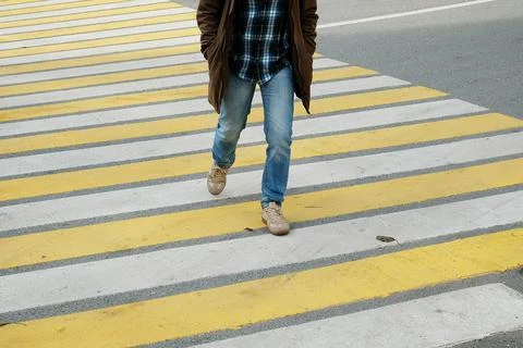 Man crossing the street on a pedestrian crossing Stock Photos
