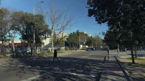 Man crossing street on red light at crosswalk, jaywalking, Madrid 스톡 동영상 329510023