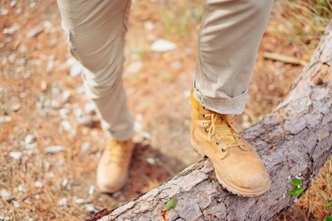Man crossing tree trunk Stock Photos