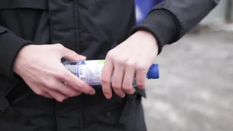 Man crumples a plastic bottle Stock Footage 82025828