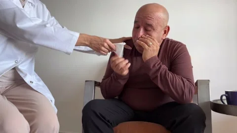 Man crying during therapy while receiving support from therapist Stock Footage 346719260
