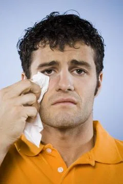 Man crying with tissue Foto stock